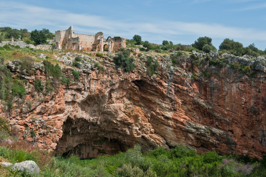 Ancient Byzantine ruins sit on the edge of a sink hole March 31, 2013, at Kanlidivane, Turkey. Legend explains that wrong doers would be hurled into the sink hole to pay for their crimes, where wild animals awaited them. Kanlidivane is one of several trips offered by various agencies at Incirlik Air Base, Turkey. (U.S. Air Force photo by Senior Airman Daniel Phelps/Released)