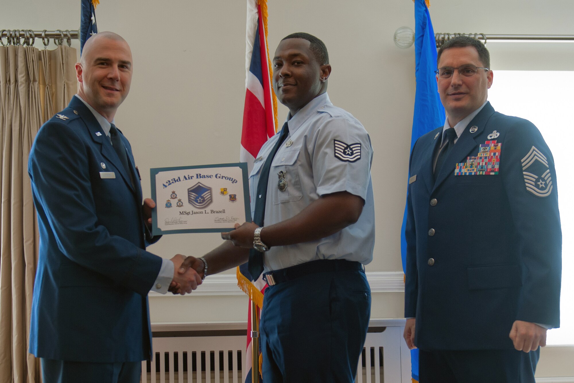 RAF ALCONBURY, United Kingdom – Master Sgt. Jason Brazell, 423rd Security Forces Squadron, receives his certificate for promotion to master sergeant from Col. Michael Reiner, 423rd Air Base Group commander, April 30 at the Stukeley Inn on RAF Alconbury. (U.S. Air Force photo by Staff Sgt. Brian Stives)