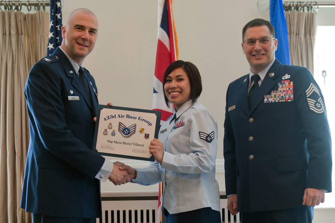 RAF ALCONBURY, United Kingdom – Staff Sgt. Maria Muriel Villareal, 423rd Communications Squadron, receives her certificate for promotion to staff sergeant from Col. Michael Reiner, 423rd Air Base Group commander, April 30 at the Stukeley Inn on RAF Alconbury. (U.S. Air Force photo by Staff Sgt. Brian Stives)