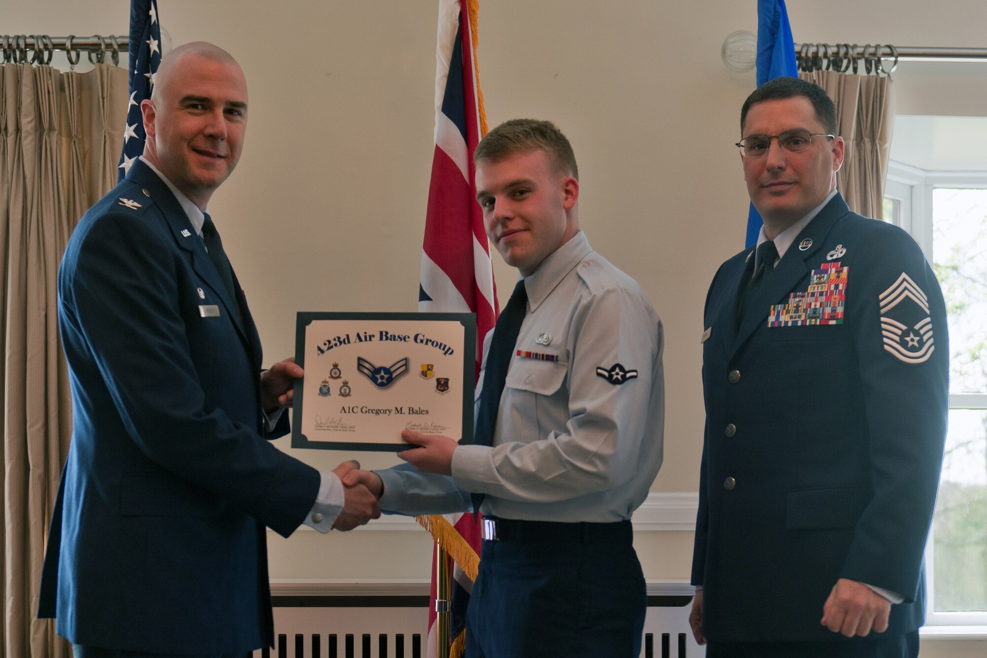 RAF ALCONBURY, United Kingdom – Airman 1st Class Gregory Bales, 423rd Communications Squadron, receives his certificate for promotion to airman 1st class from Col. Michael Reiner, 423rd Air Base Group commander, April 30 at the Stukeley Inn on RAF Alconbury. (U.S. Air Force photo by Staff Sgt. Brian Stives)