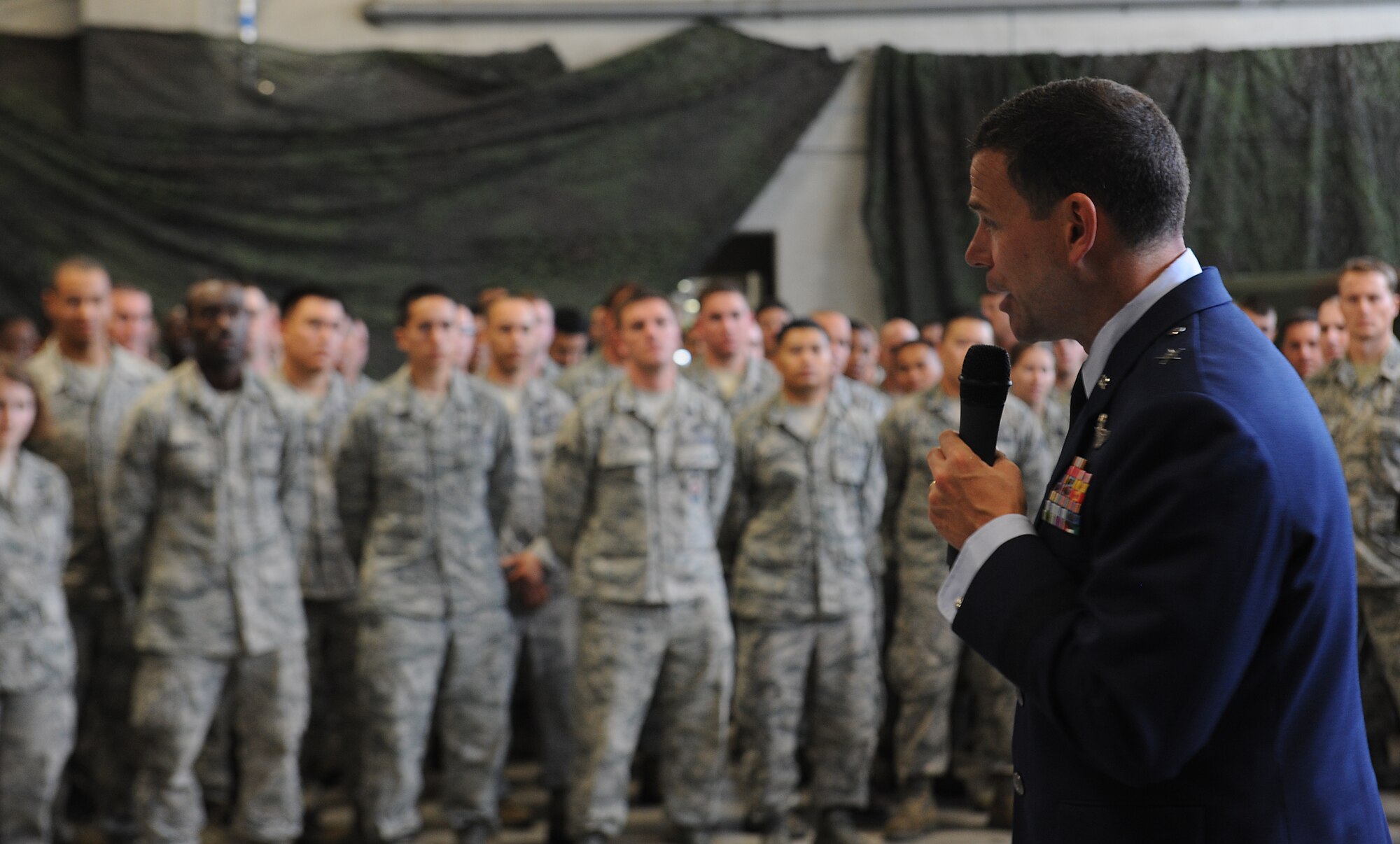 U.S. Air Force Brig. Gen. Matt Molloy, 18th Wing commander, thanks the 18th Civil Engineer Group for their hard work during his command on Kadena Air Base, Japan, April 30, 2013. The general also recognized outstanding performers within the group after presenting Combat Action Medals to Staff Sgts. Michael Vallejo and Craig Zehrbach, 18th Civil Engineer Squadron explosive ordinance disposal technicians. (U.S. Air Force photo by Airman 1st Class Malia Jenkins/Released)