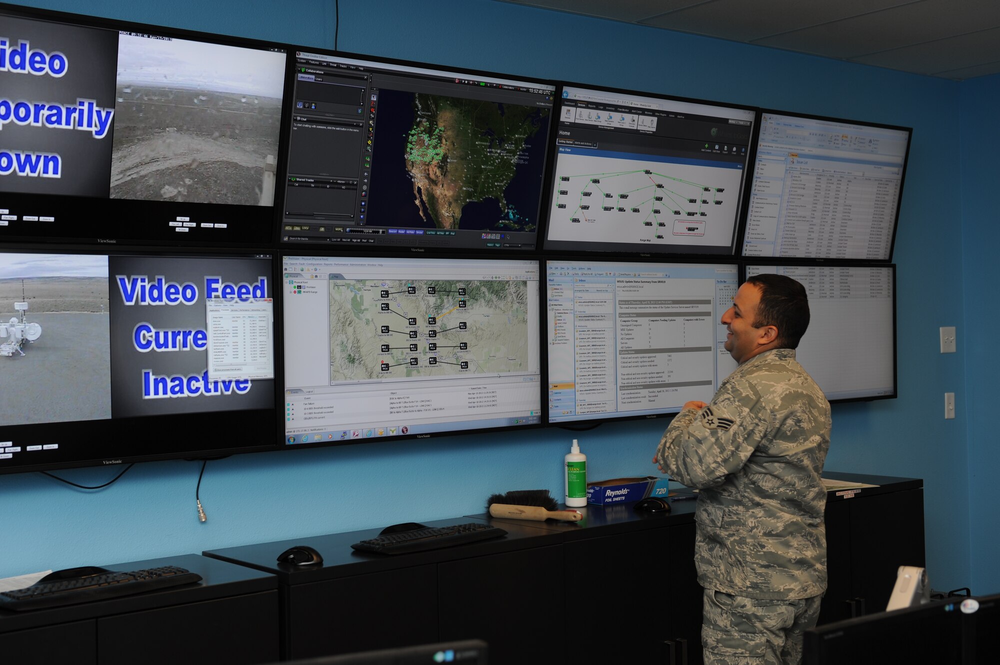 U.S. Air Force Senior Airman Daniel Santiago, 266th Range Squadron cyber transport journeyman, looks across the many computer screens inside the operations center April 19, 2013, at Mountain Home Air Force Base, Idaho. Communication across the vast expanse of the Mountain Home Range Complex is a challenge therefore RANS members have multiple sites set up across the vast expanse of Idaho desert in order to provide maximum communication coverage. (U.S. Air Force photo by Senior Airman Benjamin Sutton/Released)