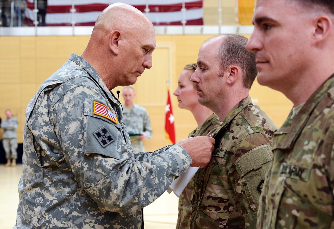 U.S. Army Chief of Staff Gen. Ray Odierno pins the Bronze Star onto Chief Warrant Officer 4 Robert Rupe during a visit to Lucius D. Clay Kaserne, formerly Wiesbaden Army Airfield, in Wiesbaden, Germany, April 30, 2013.