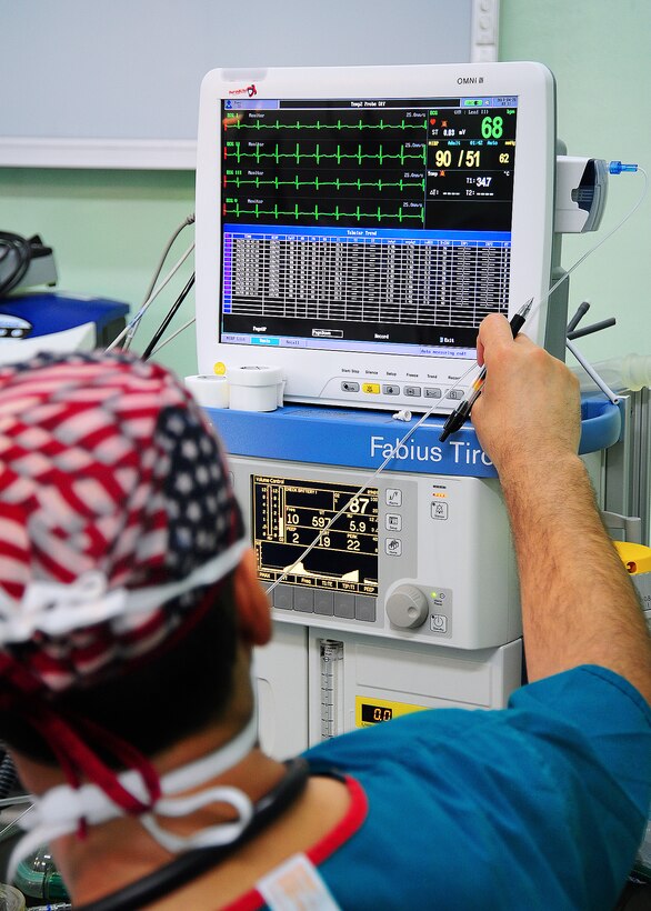 U.S. Army Maj. Fred Grois adjusts a patient's ventilator during a training exercise as part of New Horizons 2013 at Western Regional Hospital in Belmopan, Belize, April 24, 2013. Grois, an anesthesia resident, is assigned to San Antonio Military Medical Center on Fort Sam Houston, Texas.