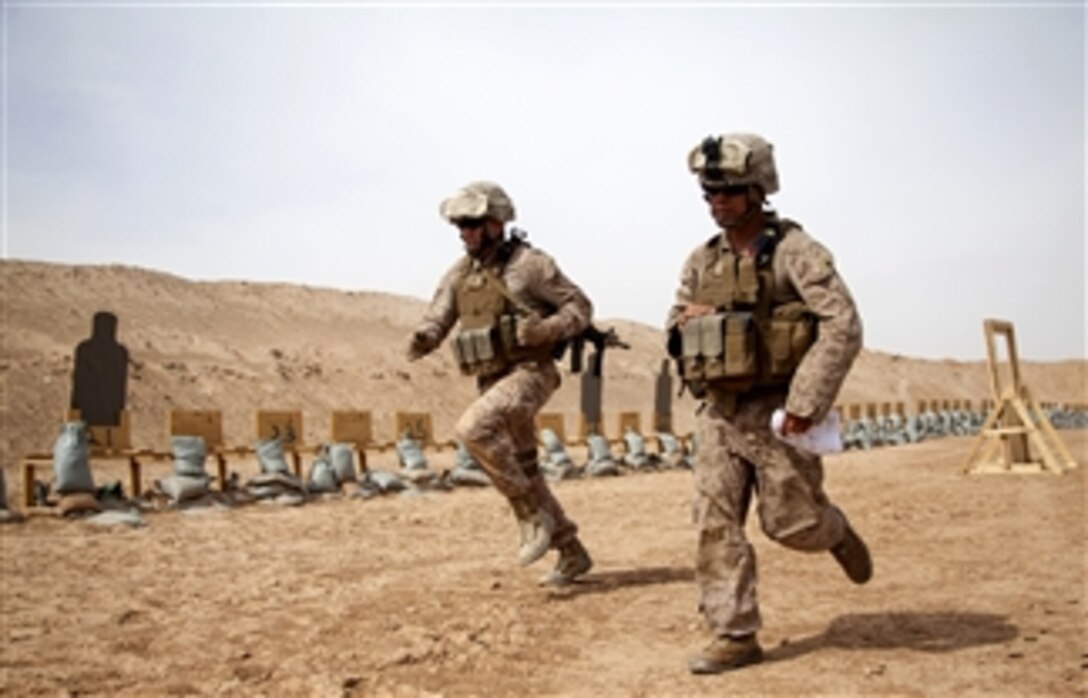 U.S. Marine Corps 1st Lt. Brent Bonnema, left, and Cpl. Fred Barba run between stations while conducting small arms live-fire training at Camp Leatherneck in the Helmand province of Afghanistan on April 25, 2013.  The live-fire course requires participants to maneuver and fire from different stations while being timed.  Bonnema and Barba are assigned to the Afghan National Civil Order Police Kandak 1 Adviser Team, Regimental Combat Team 7. 