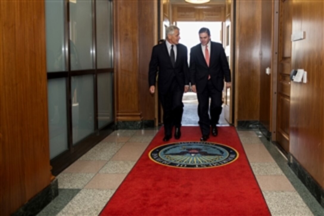 Secretary of Defense Chuck Hagel, left, escorts Colombia's Minister of Defense Juan Carlos Pinzon into the Pentagon on May 1, 2013.  Hagel, Pinzon and their senior advisors will meet to discuss security items of interest to both nations.  