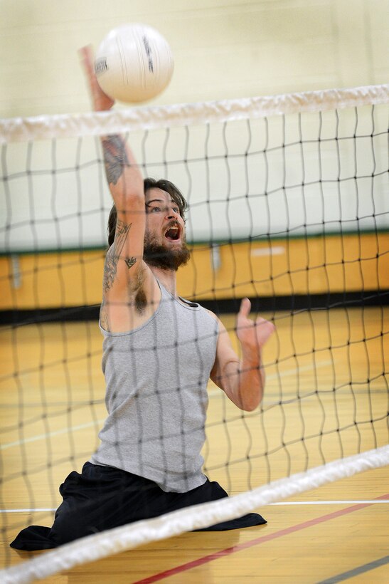 Marine Cpl. Ray Hennagir practices sitting volleyball with his teammates in Colorado Springs, Colo. He will compete for the Marine team during the 2013 Wounded Warrior Games at the U.S. Olympic Training Center and at the Air Force Academy in Colorado Springs, Colo., May 11-17. Throughout the seven-day event, wounded, ill and injured service members and veterans from the Marines, Army, Air Force, Navy, Coast Guard and Special Operations Command will compete for the gold in track and field, shooting, swimming, cycling, archery, wheelchair basketball and sitting volleyball.  