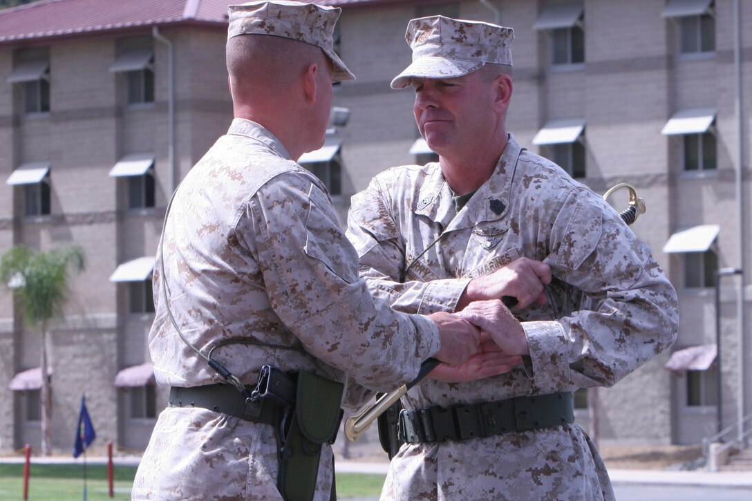 Sergeant Maj. Douglas E. Berry Jr., right, incoming sergeant major, Combat Logistics Regiment 15, 1st Marine Logistics Group, is handed a noncommissioned officer sword from Col. Tracy W. King, commanding officer, CLR-15, signifying his new appointment as the regimental sergeant major during CLR-15’s Relief and Appointment Ceremony aboard Camp Pendleton, Calif., May 1, 2013. Berry, a former rifleman and 25-year Marine Corps veteran, looks forward to his new duty as the regimental sergeant major.
