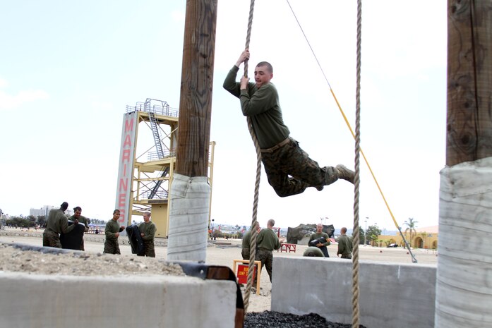 Recruits of Company G, 2nd Recruit Training Battalion, get to the other side of the ditch using a rope to swing across it during the Confidence Course aboard Marine Corps Recruit Depot San Diego April 16.