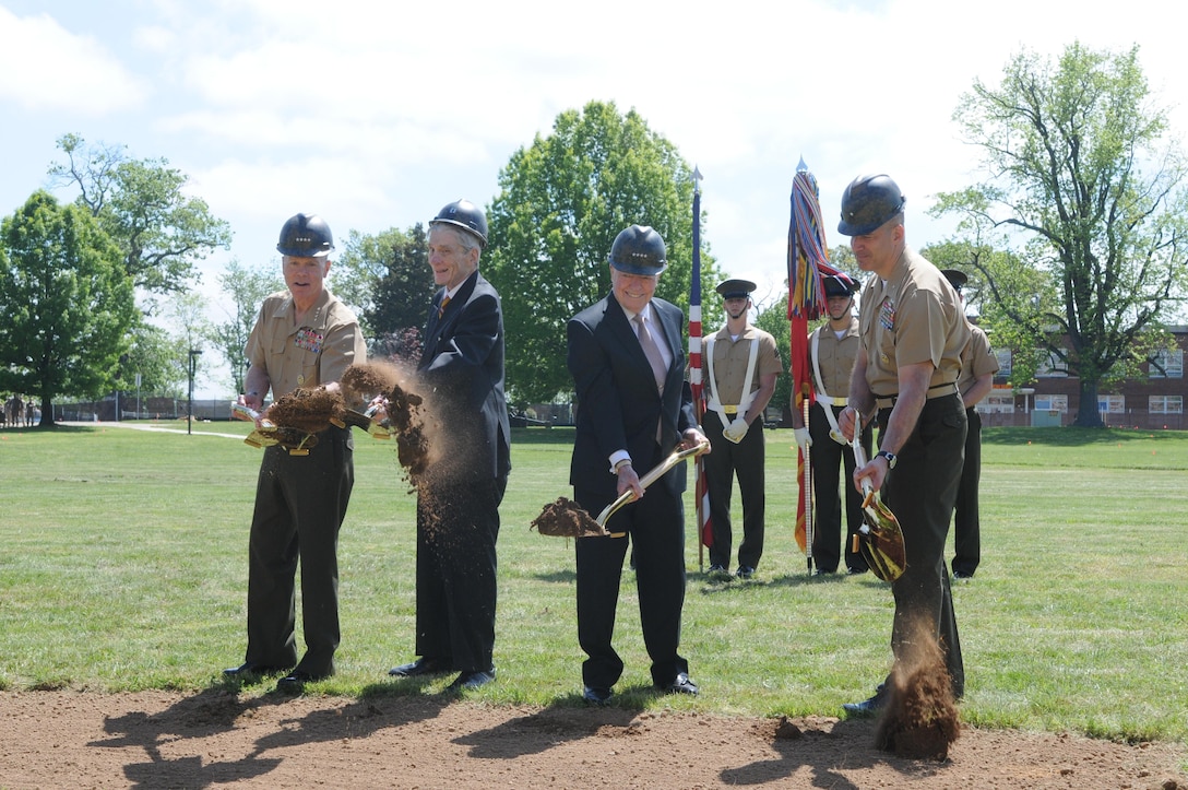 From left, Gen. James F. Amos, commandant of the Marine Corps; retired Sen. John Warner, retired Gen. Alfred M. Gray, Jr., 29th commandant of the Marine Corps; and Brig. Gen. William Mullen III, commanding general of Education Command and president of Marine Corps University, move the first shovels-full of dirt in the construction of the 129,000-square foot John Warner Center for Advanced Military Studies at a groundbreaking ceremony May 2, 2013. The building will be an extension of Marine Corps University and will house the Command and Staff College, the Marine Corps War College and the School of Advanced Warfighting. 