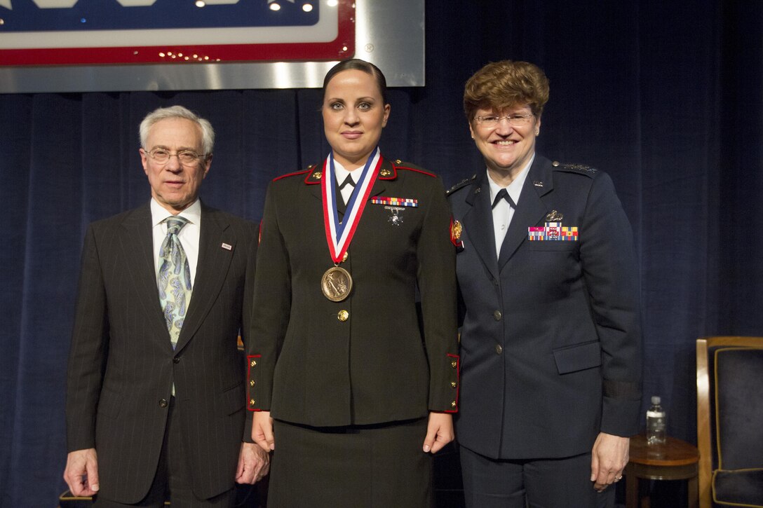Cpl. MaryBeth Monson stands beside Air Force Gen. Janet C. Wolfenbarger and retired Army Col. Jack H. Jacobs after being awarded the Military Leadership Award, May 2, at The Pierre Hotel during the 2013 USO Woman of the Year Luncheon.  Monson is an aircraft intermediate level structures mechanic with Marine Aviation Logistics Squadron 13, Marine Aircraft Group 13, 3rd Marine Aircraft Wing, I Marine Expeditionary Force.  Wolfenbarger is the commander of Air Force Materiel Command and the USO Woman of the Year.  Jacobs is a Medal of Honor recipient and was a special guest speaker during the event.  (U.S. Marine Corps photo by Lance Cpl. Daniel E. Valle).