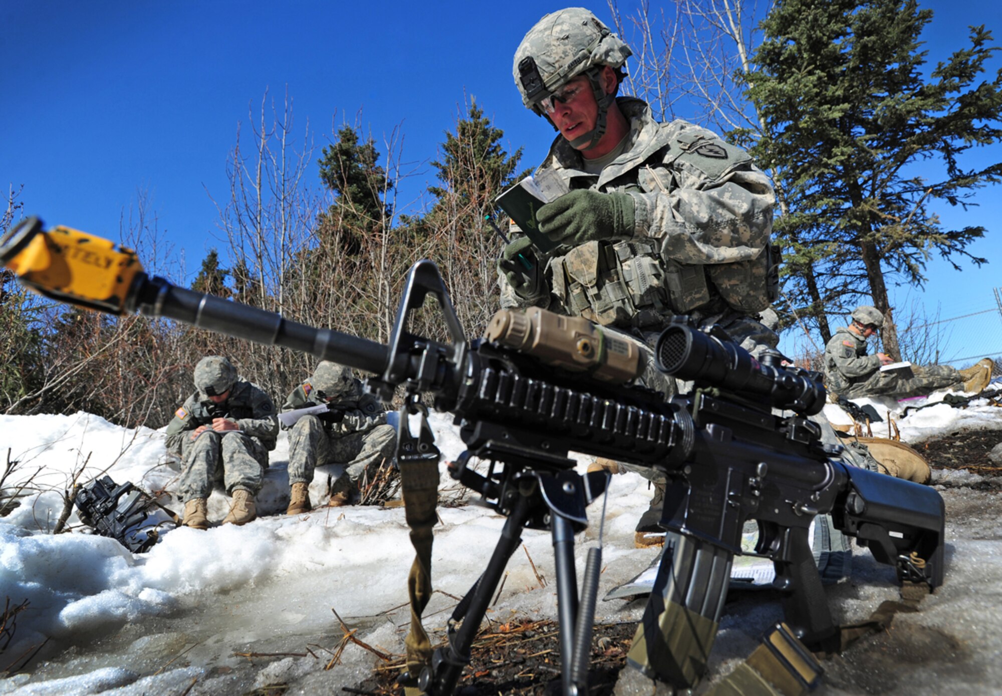 Sgt. John Hately, a native of Fort Belvoir, Va., assigned to D Company 3rd Battalion (Airborne) 509th Infantry Regiment, calculates his next move during the day land navigation course April 22. (U.S. Air Force photo/Justin Connaher)