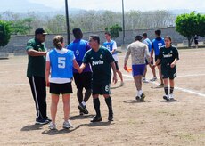 Honduran and Joint Task Force-Bravo officers shake hands after a soccer match during a day of friendly competitions at the annual Camaraderie Day event, April 26. The Honduran military team beat the Americans 2-1 and took home the overall championship trophy.(Photo by Ana Fonseca)