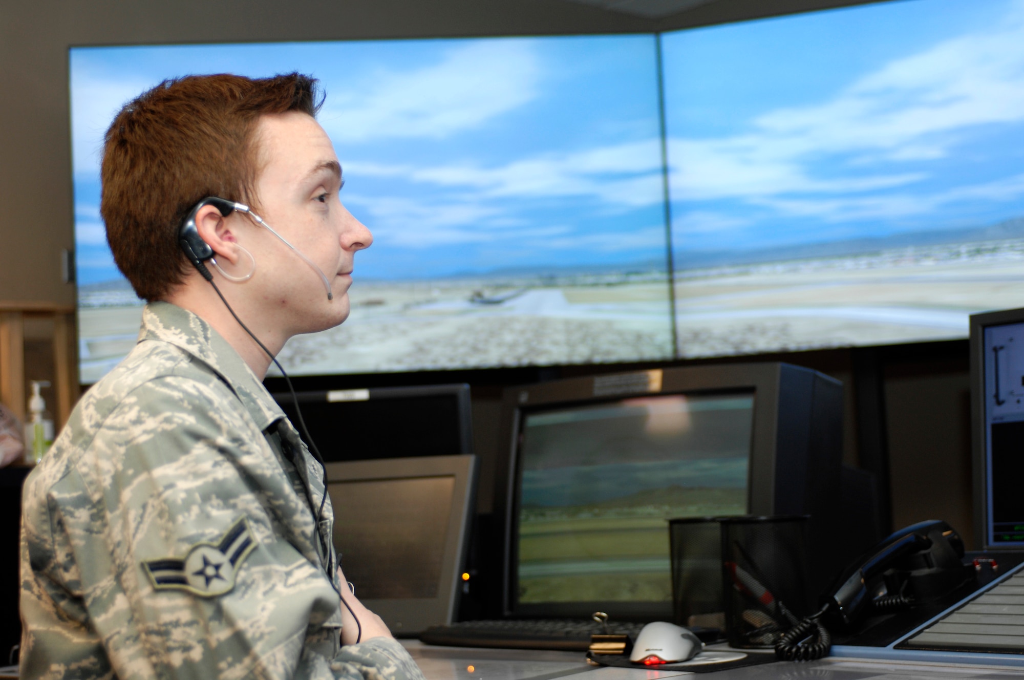 Airman 1st Class Brandon White, 57th Operations Support Squadron air traffic control apprentice, practices communicating with virtual aircraft on a simulator April 25, 2013. White is one of many new controllers undergoing training at Nellis and utilizing a simulator to hone skills required to control aircraft effectively. (U.S. Air Force photo by Airman 1st Class Joshua Kleinholz)