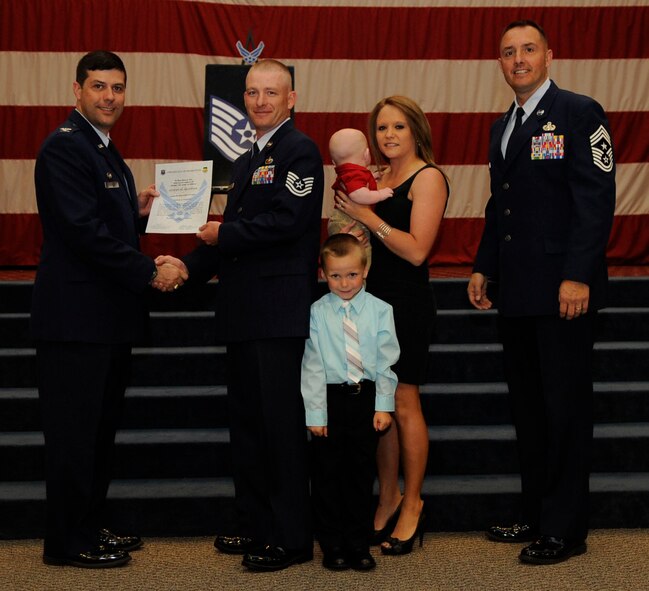Tech. Sgt. Steven Huffines, 2nd Contracting Squadron, receives a certificate of promotion to Tech. Sgt. from Col. Andrew Gebara, 2nd Bomb Wing Commander, during the May Wing Promotion Ceremony on Barksdale Air Force Base, La., May 1, 2013.