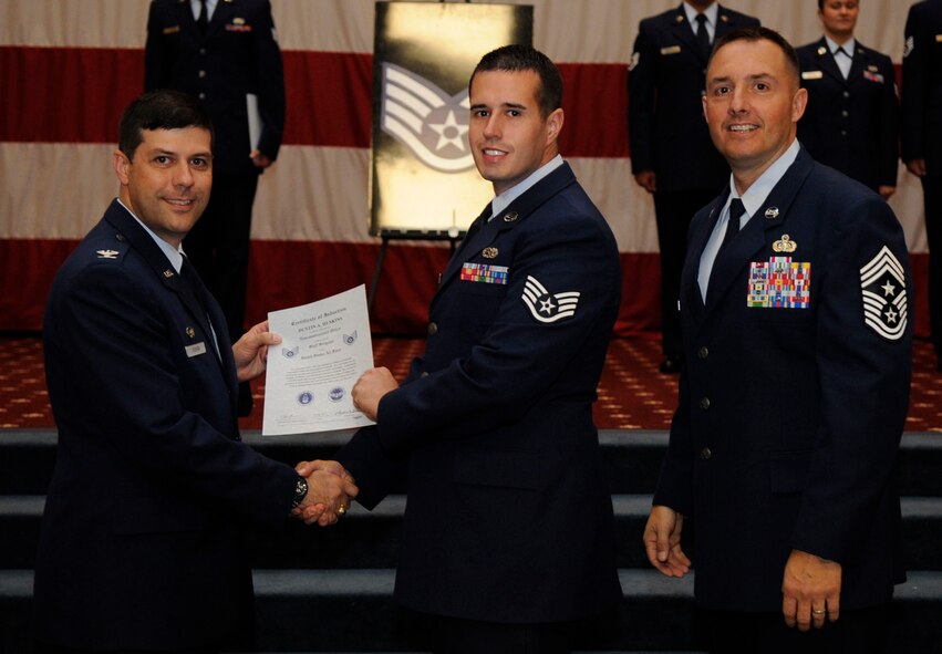 Staff Sgt. Dustin Huskins, 2nd Maintenance Squadron, receives a certificate of promotion to Staff Sgt. from Col. Andrew Gebara, 2nd Bomb Wing Commander, during the May Wing Promotion Ceremony on Barksdale Air Force Base, La., May 1, 2013.