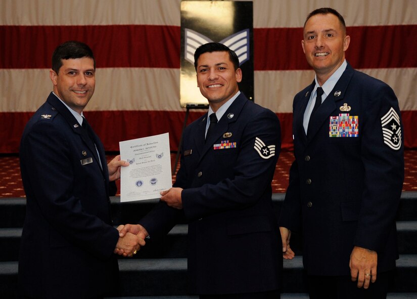 Staff Sgt. Joseph Senteno, 2nd Comptroller Squadron, receives a certificate of promotion to Staff Sgt. from Col. Andrew Gebara, 2nd Bomb Wing Commander, during the May Wing Promotion Ceremony on Barksdale Air Force Base, La., May 1, 2013.