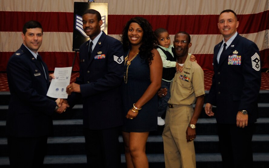 Staff Sgt. Roderick Burse, 2nd Aircraft Maintenance Squadron, receives a certificate of promotion to Staff Sgt. from Col. Andrew Gebara, 2nd Bomb Wing Commander, during the May Wing Promotion Ceremony on Barksdale Air Force Base, La., May 1, 2013.