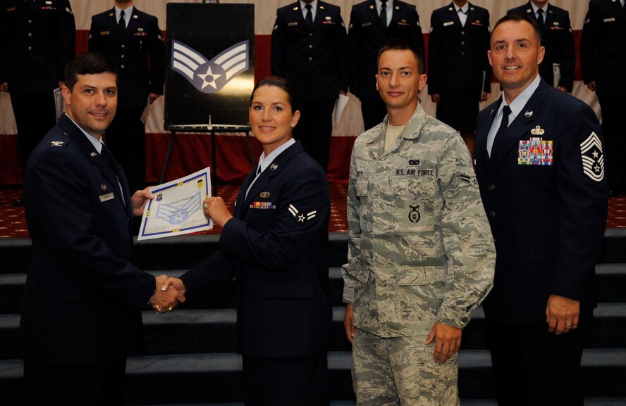 Airman 1st Class Morgan Petty, 2nd Security Forces Squadron, receives a certificate of promotion to Senior Airman from Col. Andrew Gebara, 2nd Bomb Wing Commander, during the May Wing Promotion Ceremony on Barksdale Air Force Base, La., May 1, 2013.