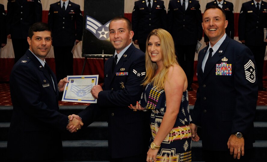 Airman 1st Class Peter O?neil, 2nd Security Forces Squadron, receives a certificate of promotion to Senior Airman from Col. Andrew Gebara, 2nd Bomb Wing Commander, during the May Wing Promotion Ceremony on Barksdale Air Force Base, La., May 1, 2013.
