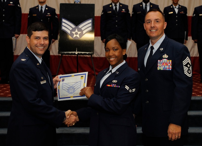 Airman 1st Class Karin Puckett, 2nd Operations Support Squadron, receives a certificate of promotion to Senior Airman from Col. Andrew Gebara, 2nd Bomb Wing Commander, during the May Wing Promotion Ceremony on Barksdale Air Force Base, La., May 1, 2013.