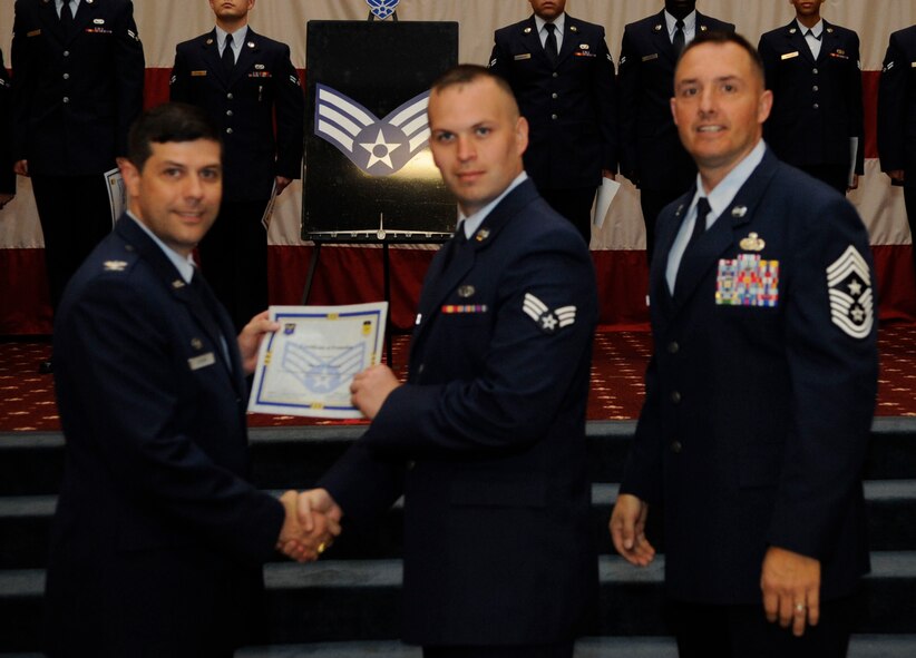 Airman 1st Class Brian Maher, 2nd Munitions Squadron, receives a certificate of promotion to Senior Airman from Col. Andrew Gebara, 2nd Bomb Wing Commander, during the May Wing Promotion Ceremony on Barksdale Air Force Base, La., May 1, 2013.