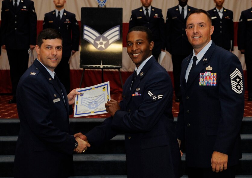 Airman 1st Class Darrien Hines, 2nd Munitions Squadron, receives a certificate of promotion to Senior Airman from Col. Andrew Gebara, 2nd Bomb Wing Commander, during the May Wing Promotion Ceremony on Barksdale Air Force Base, La., May 1, 2013.