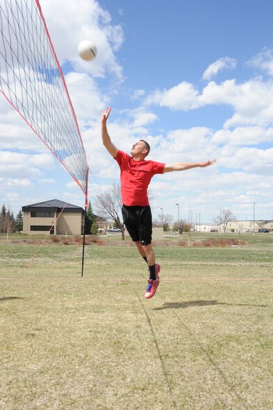 Capt. Nick Saccone, 819th RED HORSE Squadron project manager, spikes a ball during a volleyball game against the 341st Operations Squadron during the quarterly Wing Sports Smackdown at the Grizzly Bend on April 25. Saccone and his team beat their opponents with a final score of 15-8. (U.S. Air Force photo/Airman 1st Class Katrina Heikkinen)