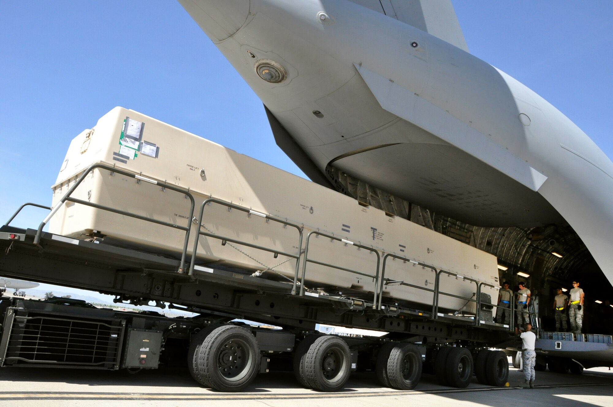 Airmen from the 60th Aerial Port Squadron and 74th APS out of Lackland, Texas load a special crate containing an unassembled Unmanned Arial Vehicle onto a C-17 Globemaster III April 30, 2013 on Travis.