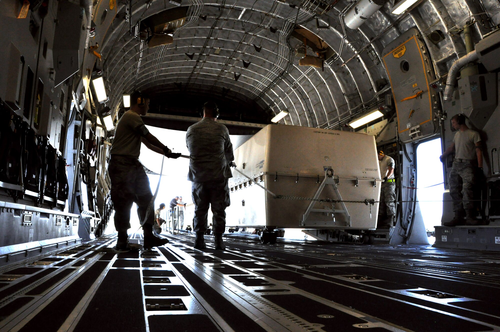 Airmen from the 60th Aerial Port Squadron and 74th APS out of Lackland, Texas load a special crate containing an unassembled Unmanned Arial Vehicle onto a C-17 Globemaster III April 30, 2013 on Travis.