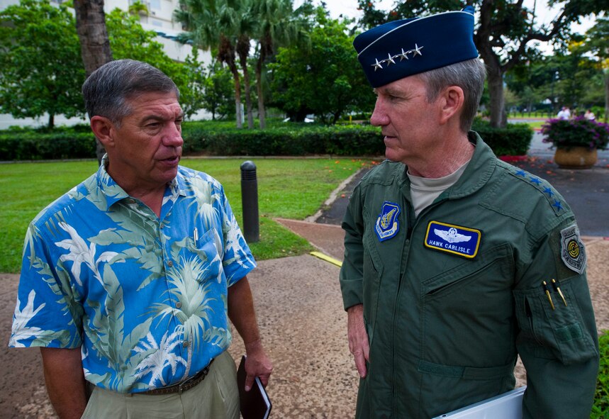 Retired Air Force Lt. Gen. Dan Leaf (left), Asia-Pacific Center for Security Studies director, speaks with Gen. Hawk Carlisle, commander of Pacific Air Forces, after Carlisle's arrival at the APCSS , in Honolulu, Hawaii. The APCSS mission is building capacities and communities of interest by educating, connecting, and empowering security practitioners to advance Asia-Pacific security.  (U.S. Air Force photo by Staff Sgt. Nathan Allen)