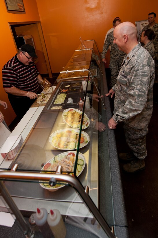 Base leaders wait in line to sample new menu options a food tasting in the newly-renovated dining room at the Dakota’s Club on Ellsworth Air Force Base, S.D., April 30, 2013. Along with the base dining facility, Prairie Ridge Golf Course and Bandit Recreation Center, the new dining room will provide campus-style dining available for use by Airmen on meal cards. (U.S. Air Force photo by Airman 1st Class Kate Thornton-Maurer/Released) 