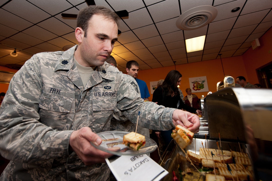 Lt. Col. Heath Frye, 28th Communications Squadron commander, serves himself a vegetarian panini at a food tasting in the newly-renovated dining room at the Dakota’s Club on Ellsworth Air Force Base, S.D., April 30, 2013. The new dining room is part of Ellsworth’s food transformation project that will provide the base community with a greater variety of places to eat, as well as more menu options. (U.S. Air Force photo by Airman 1st Class Kate Thornton-Maurer/Released) 
