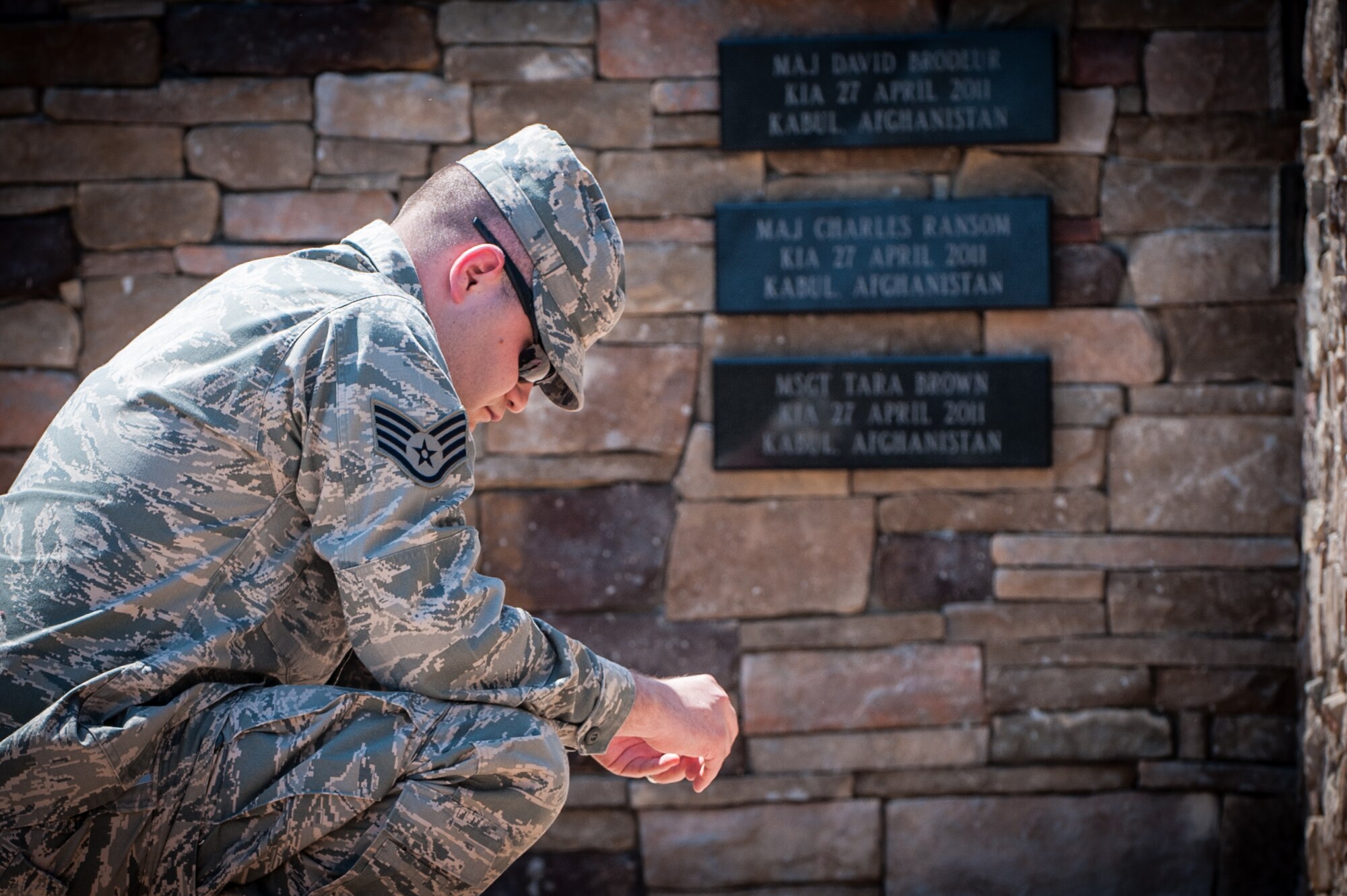 Staff Sgt. Jerrod Smith, 305th Operations Support Squadron weather forecaster, pauses for a moment at the Air Advisor Memorial Remembrance Ceremony April 26, 2013, at Joint Base McGuire-Dix-Lakehurst, N.J.  The event commemorated the two-year anniversary of the shooting in Kabul, Afghanistan, that claimed the lives of nine Air Advisors April 27, 2011.  Smith worked with one of the fallen, Capt. Nathan Nylander, 25th Operational Weather Squadron commander, at Davis-Monthan Air Force Base, Ariz. Smith hails from Dover-Foxcroft, Maine. (U.S. Air Force photo by Russ Meseroll/Released)