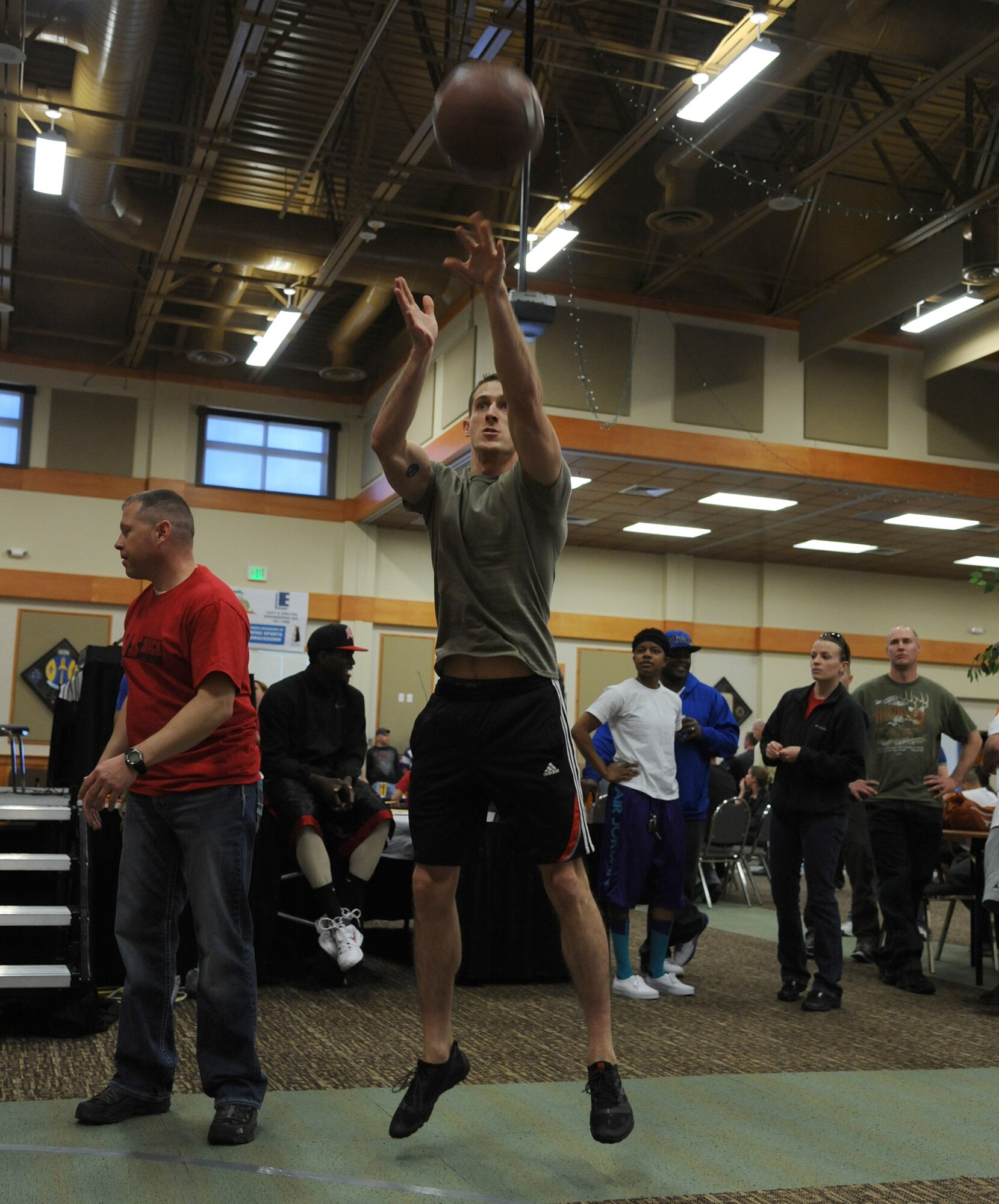 Senior Airman Thomas Hofkens, 341st Contracting Squadron contract specialist, throws a basketball during one of many events at Wing Sports Smackdown. Hofkens earned a total 22 shots in the popular event. (U.S. Air Force photo/Airman 1st Class Katrina Heikkinen)


