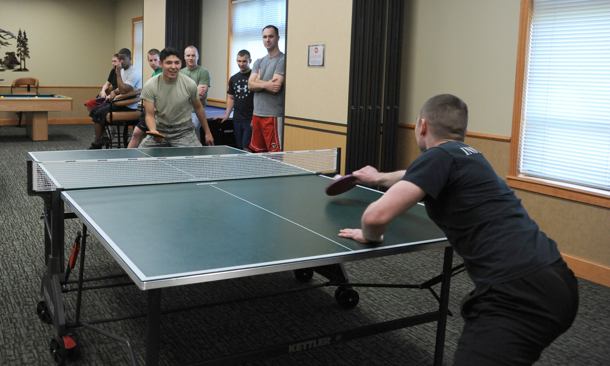 First Lt. Stigen Westberg, 341st Operations Support Squadron ICBM instructor deputy commander, (right) dominates a game of pingpong against Airman 1st Class Daniel Torres, 819th RED HORSE Squadron member, with a final score of 12-10. Airmen had the opportunity to play a variety of games including cornhole, volleyball, sumo wrestling and dance central. (U.S. Air Force photo/Airman 1st Class Katrina Heikkinen)



