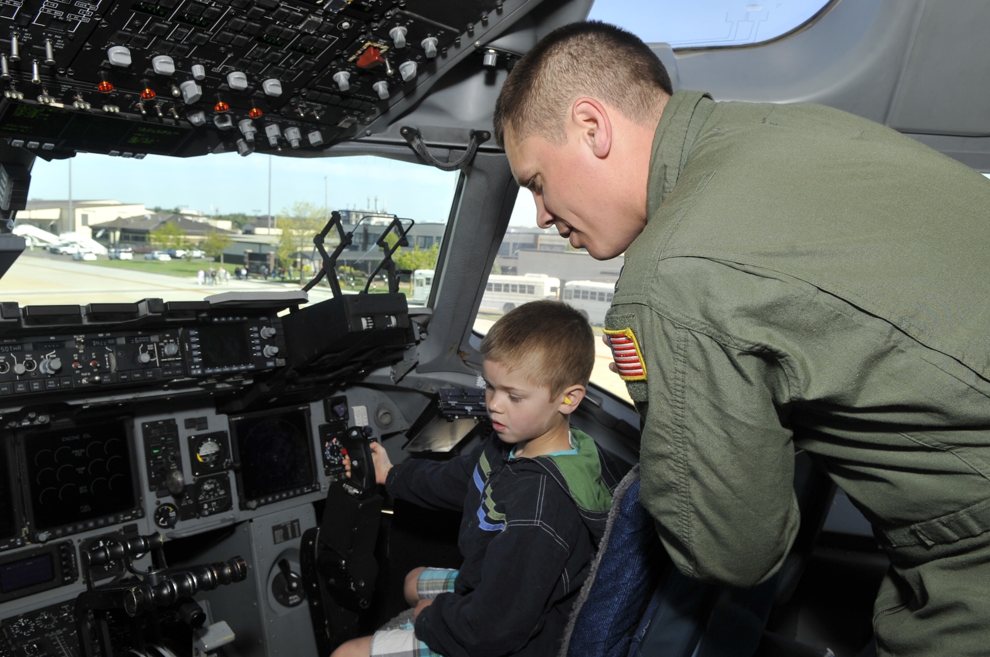 Capt. Pete Surette, 2nd Air Refueling Squadron pilot, gives a tour of the C-17 Globemaster III to his son, Andrew 6, during the 514th Air Mobility Wing's Take Your Child to Work Day April 25, 2013, on McGuire Field at Joint Base McGuire-Dix-Lakehurst, N.J. A KC-10 Extender and a C-17 Globemaster III were set up as static displays with aircrew and aircraft maintainers on hand to answer questions. Surette hails from Aberdeen, Md. (U.S. Air Force photo by Wayne Russell/Released)