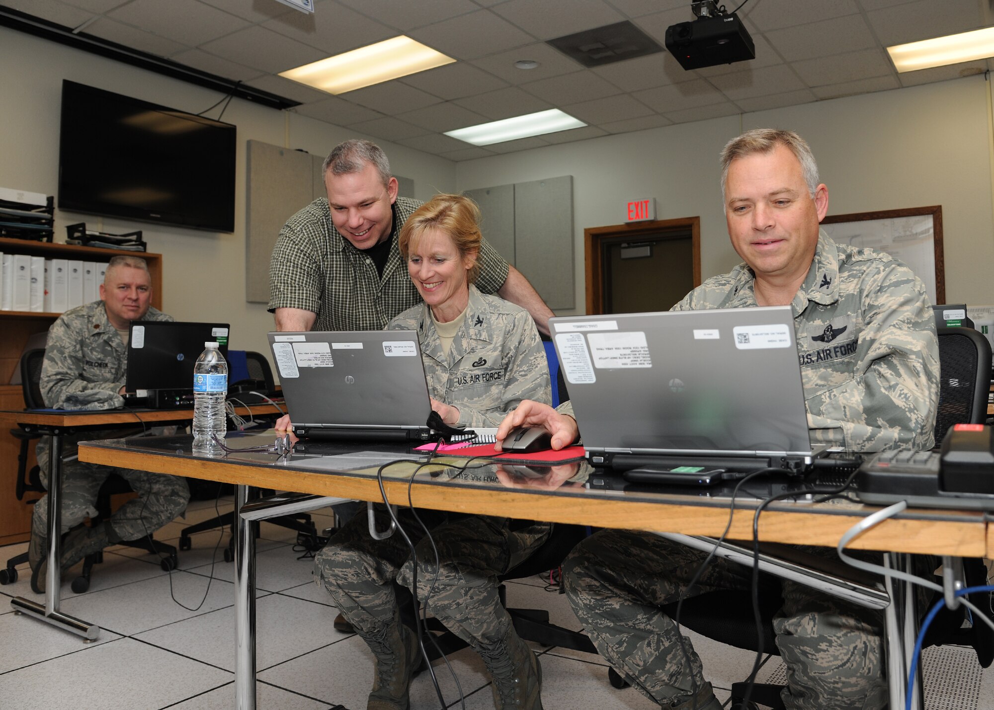 From left: Maj. John Volcheck, 319th Civil Engineer Squadron Operations Flight commander; Norm Becker, 319th CE Emergency Management & Readiness Flight Chief; Col. Carol Reece, Region Emergency Preparedness Liaison Officer FEMA Region VIII; and Col. Craig Trammell, Emergency Preparedness Liaison Officer to North Dakota; work in the Emergency Operations Center on Grand Forks Air Force Base, N.D., on May 2, 2013. The base served as a staging area in late April and early May for Federal Emergency Management Agency flood supplies that, thankfully, weren’t needed. (U.S. Air Force photo/Airman 1st Class Ashley Nicole Taylor)