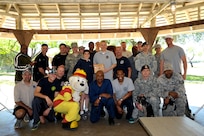 Battle of the Badges participants gather with Col. Christine Erlewine (center), 902nd Mission Support Group commander, after the 902nd CES firefighters were named the three-time champions of the annual JBSA-Randolph competition. (U.S. Air Force photo by Airman 1st Class Lincoln Korver/ Released)