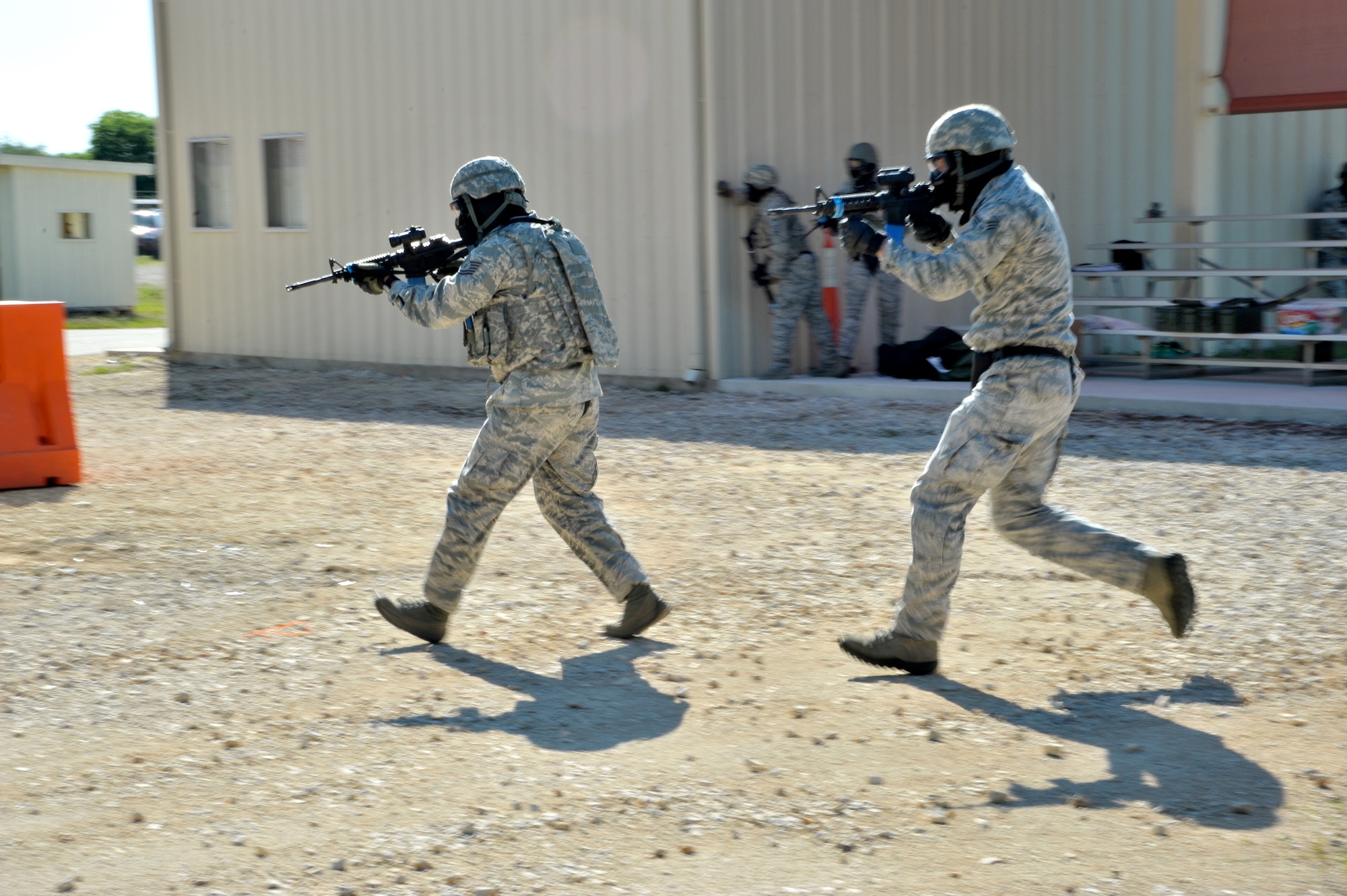 Two 902nd Security Forces Squadron members use tactical techniques in a force-on-force version of Capture the Flag during Battle of the Badges competition. (U.S. Air Force photo by Airman 1st Class Lincoln Korver/ Released)