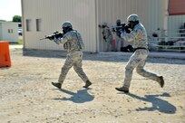 Two 902nd Security Forces Squadron members use tactical techniques in a force-on-force version of Capture the Flag during Battle of the Badges competition. (U.S. Air Force photo by Airman 1st Class Lincoln Korver/ Released)