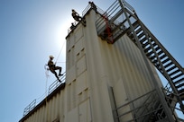 Air Force Staff Sgt. William Everett (lower left) and Airman 1st Class John Evans (upper right), 902nd Civil Engineer Squadron firefighters, demonstrate rappelling techniques at the annual JBSA-Randolph Battle of the Badges competition April 20. (U.S. Air Force photo by Airman 1st Class Lincoln Korver/ Released)