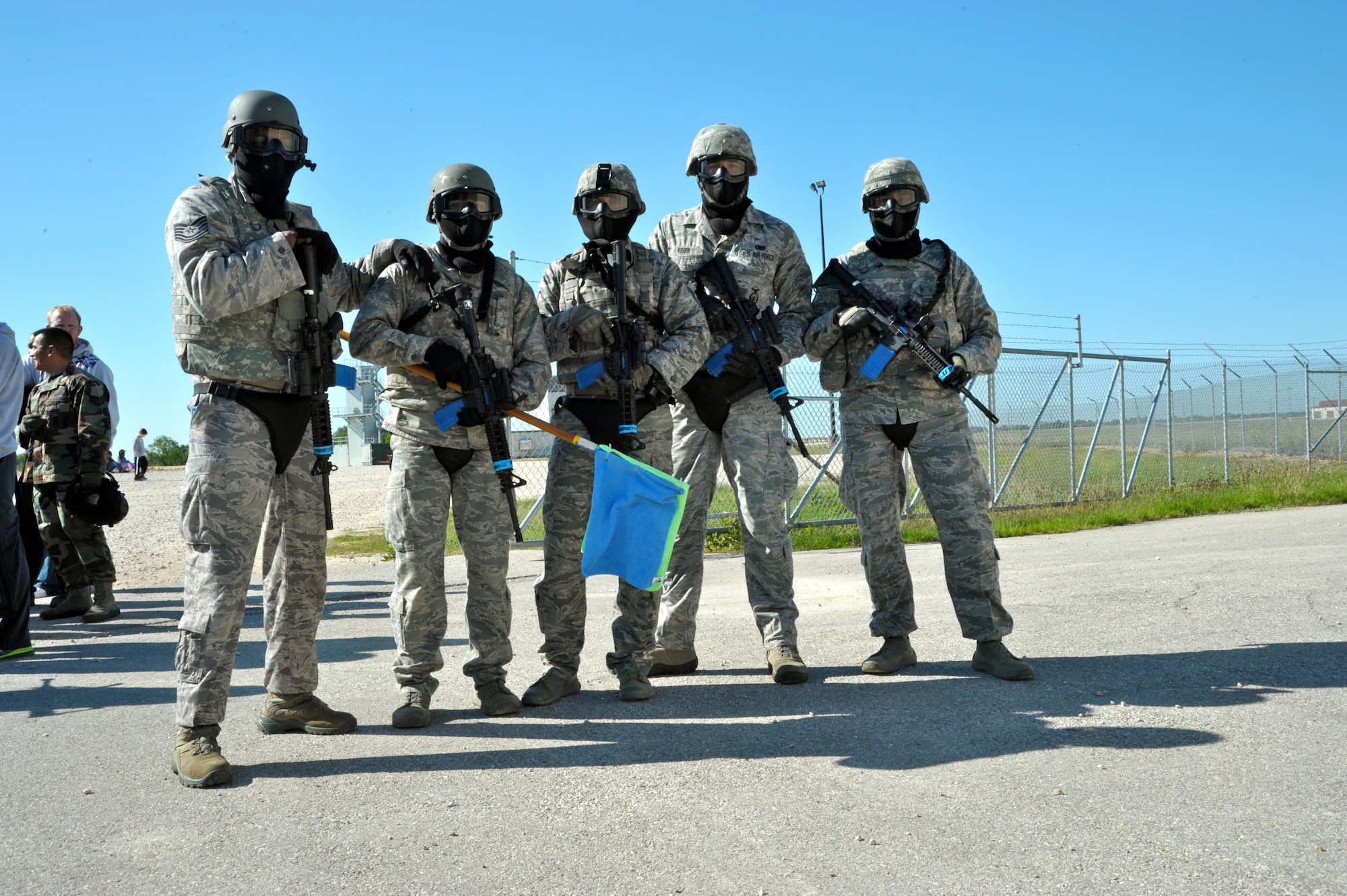 The five-man 902nd Security Forces Squadron team gathers together after defeating the 902nd Civil Engineer Squadron firefighters in Capture the Flag, the first of three events during Battle of the Badges. (U.S. Air Force photo by Airman 1st Class Lincoln Korver/ Released)