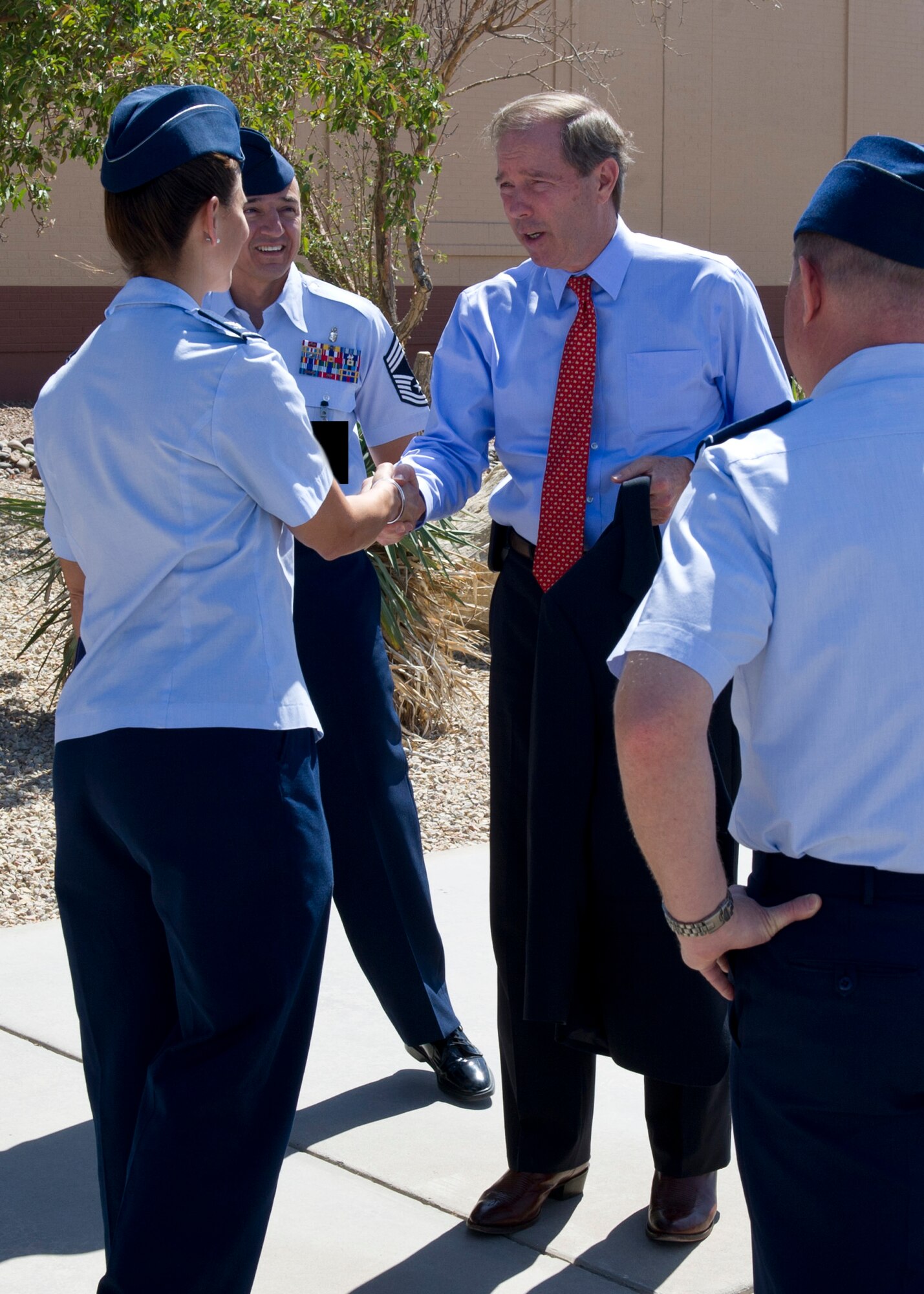 Senator Tom Udall of New Mexico, greets Col. Andrew Croft, 49th Wing commander, Col. Leslie Knight, 49th Medical Group commander, and personnel from the 49th Medical Group command staff after arriving at Holloman Air Force Base, N.M. April 29. Udall visited Holloman AFB to meet with 49th Wing leadership and see how he can help to support the base’s mission. (U.S. Air Force photo by Senior Airman DeAndre Curtiss/Released)