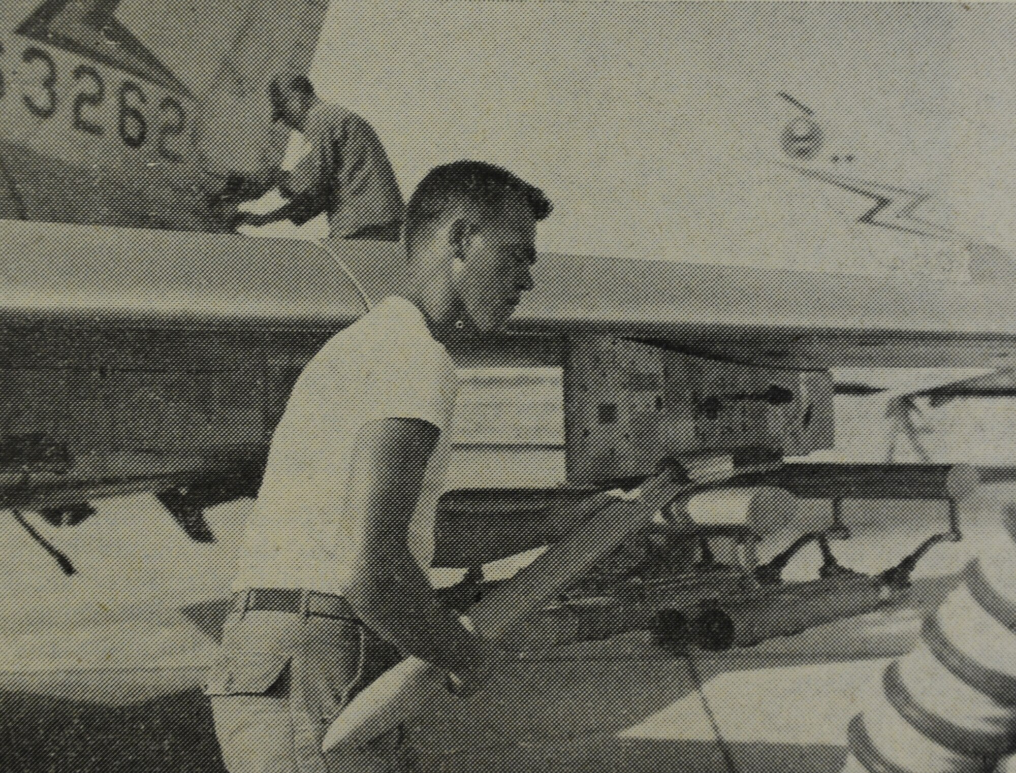 WHEELUS AB, Libya - SSgt. Raliegh Evans, 348th Munitions Maintenance Squadron, loads a rocket into the pod of an F-100 aircraft preparing for a mission over El Uotia range.