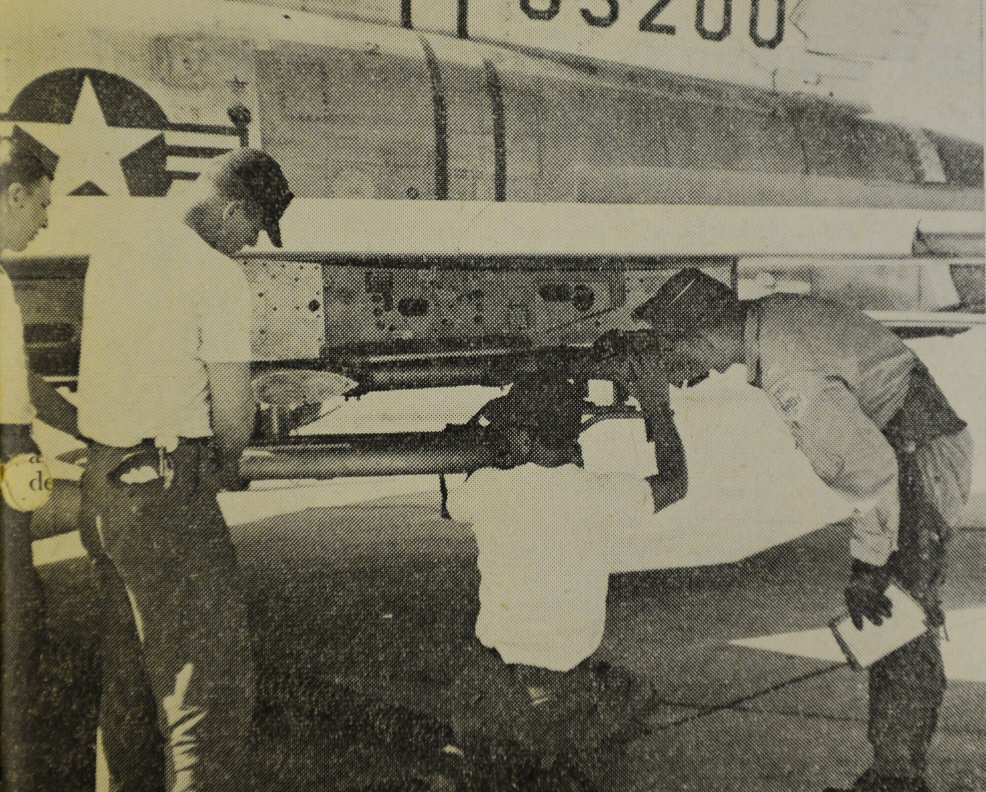 WHEELUS AB, Libya - Under 1st. Lt John Miko's (right) supervision, a weapons team load rockets on the pods of an F-100 aircraft. members of the team (left to right) are A2C Thomas Kelenske, SSgt. Gerald McKinney and SSgt. Phillip Schreier.