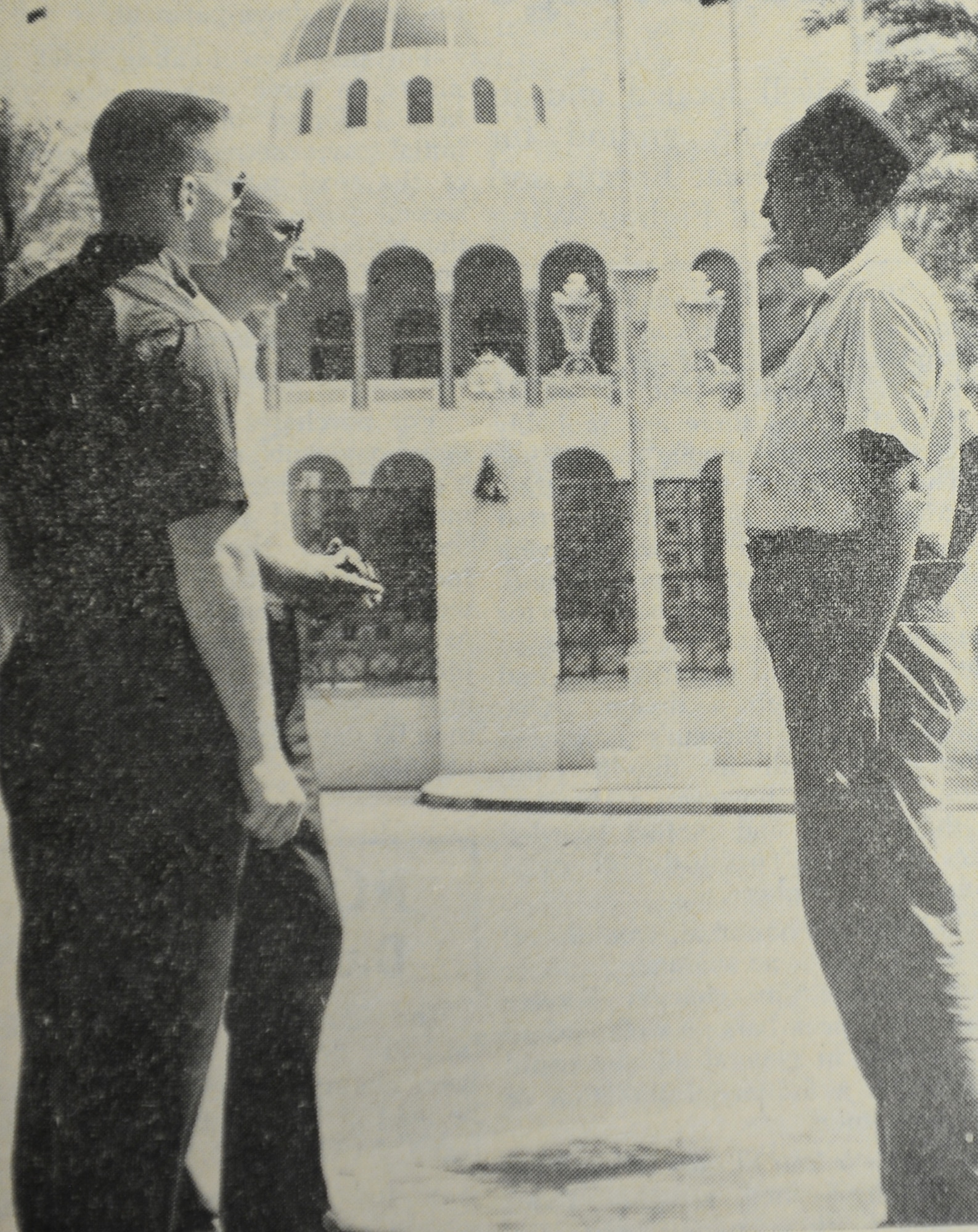 WHEELUS AB, Libya - Members of the 48th's Det. 1 at Wheelus AB, Libya ask questions of a Libyan guide on their tour of Tripoli. In the background is the palace of His Majesty King Idris I. The ruler of Libya has another palace in Torbruk.