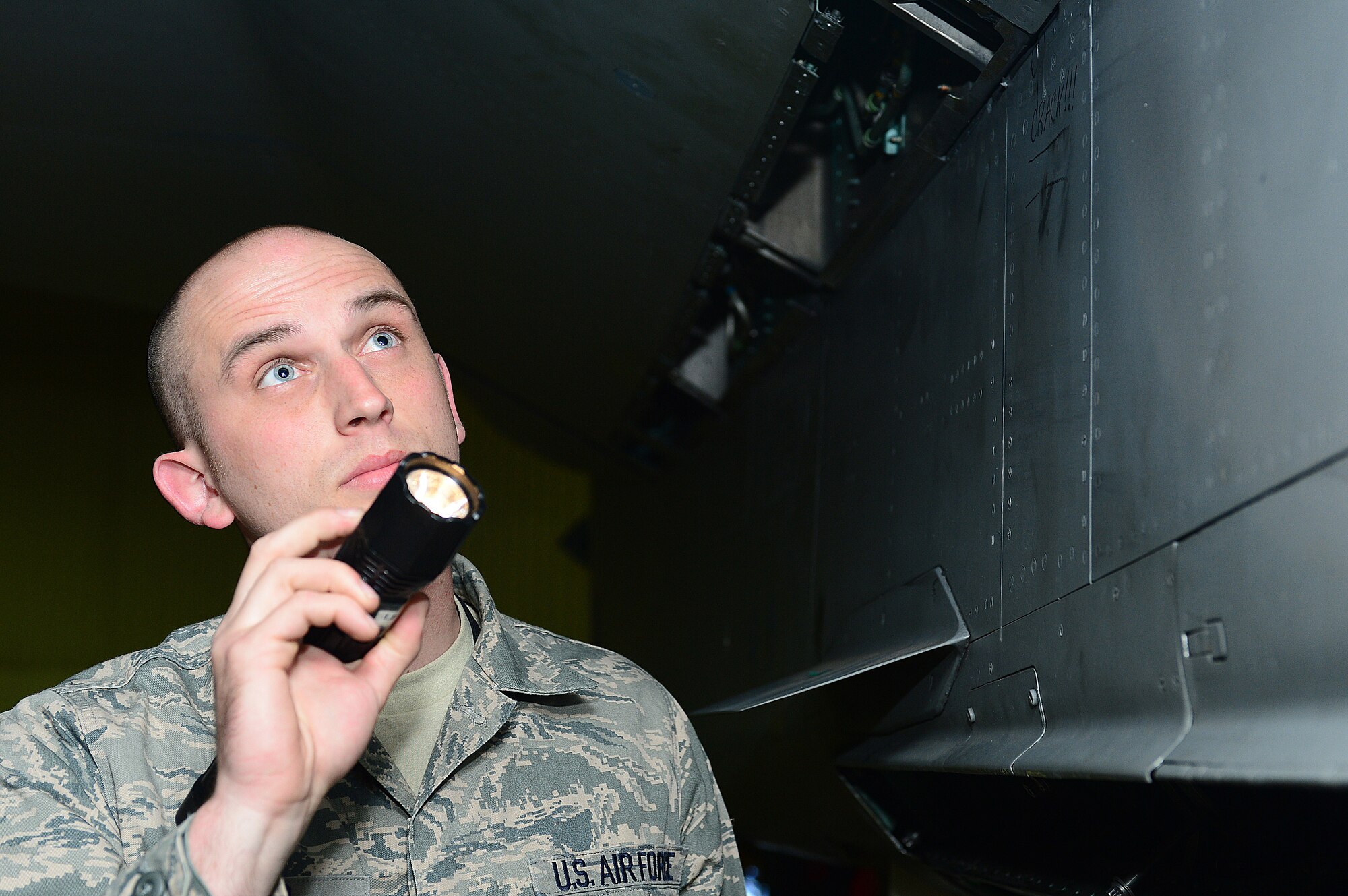 ROYAL AIR FORCE LAKENHEATH, England -- Senior Airman Robert Eland, 48th Equipment Maintenance Squadron inspection section avionics systems journeyman, inspects side panels of an F-15E Strike Eagle for discrepancies May 2, 2013. Eland was nominated for a Liberty Spotlight because he displays the core value of "Service Before Self." (U.S. Air Force photo by Airman 1st Class Dana J. Butler) 