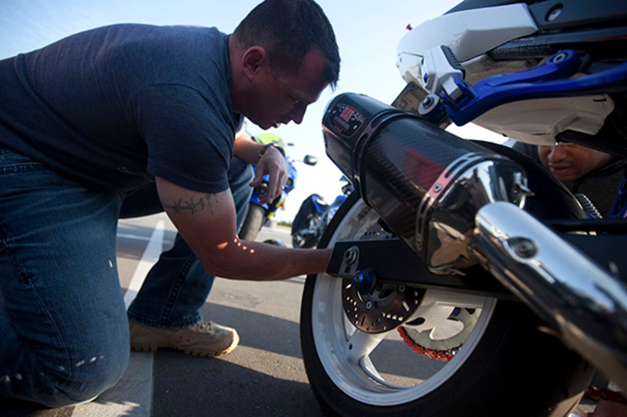 Army 1st Sgt. Thomas Abbott, checks the tire pressure of a motorcycle during a pre-ride inspection, April 26, 2013, MacDill Air Force Base, Fl. (USCENTCOM photo by Sgt. Fredrick J. Coleman).
