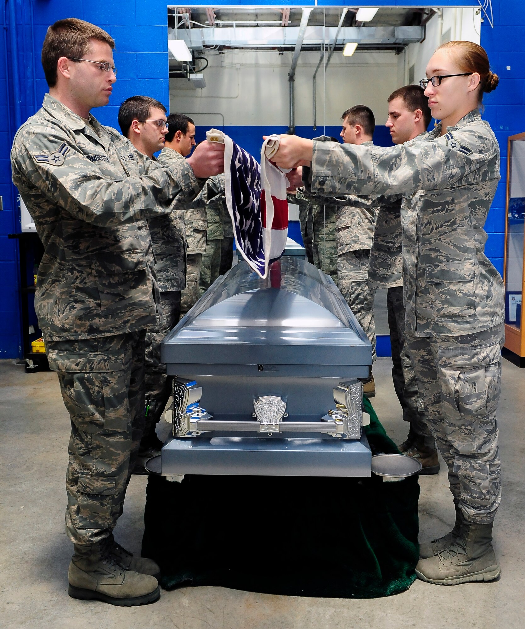 Members of the 509th Bomb Wing Honor Guard A-Team practice a seven-member flag fold for a funeral ceremony, Whiteman Air Force Base, Mo., April 23, 2013. The Honor Guard Airmen strive for perfection so they can leave a lasting impression on the family of the military member. (U.S. Air Force photo by Airman 1st Class Shelby R. Orozco/Released)